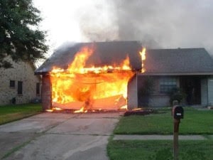 “House fire originating in the garage, a common location for electrical panel failures and overloaded circuits. Many electrical fires begin here due to outdated or damaged panels.”